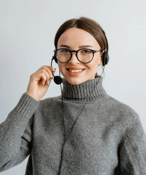 A cheerful customer service representative wearing a headset and glasses, ready to assist clients, symbolizing excellent customer support