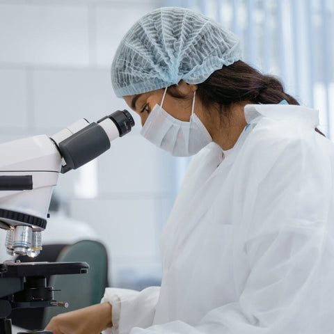 woman scientist carefully analyzes liquids